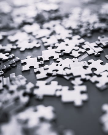 Puzzle pieces on a table, solving the puzzle is like running a business.